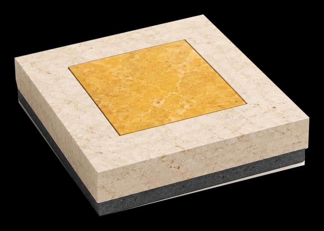 A yellow stone insert fits precisely into limestone on a basalt base, representing a well-defined appointment.